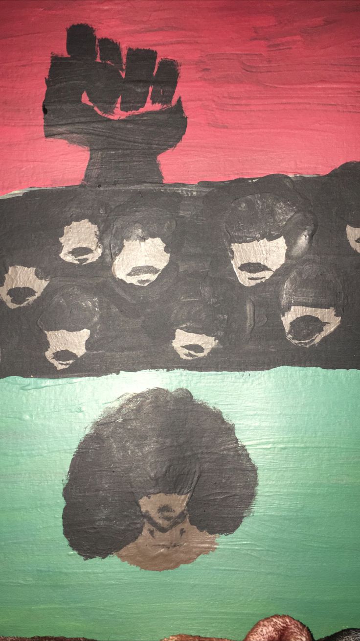 an art piece with the faces of black people painted on it, and one is in front of a red background