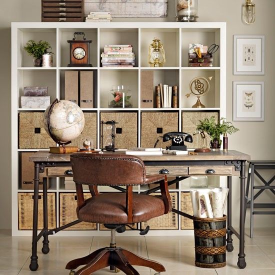 a home office with lots of bookshelves on the wall and a leather chair