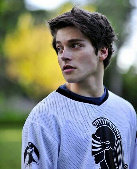 a young man is wearing a jersey with the rams on it and staring at something