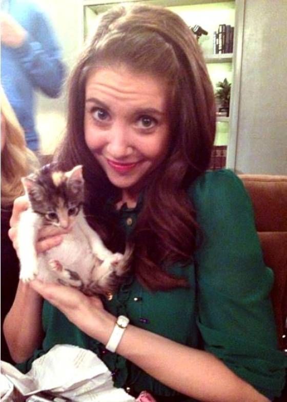 a woman holding a cat in her hands