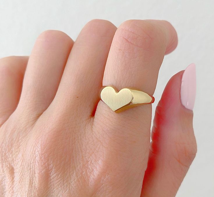 14K Solid Gold Heart Signet Ring. The Leading Trend In Jewelry Today. A Ring Full Of Love So You Can Keep It Close To Your Heart. A Beautiful Gift She Will Treasure Forever. Jewelry Comes In A Cute Gift Box Ready To Present. -All Jewelry Is New And Inspected For Quality Assurance. -Jewelry Is Crafted In Genuine High Quality 14K Gold. -We Do Not Sell Gold Plated. Product Detail: Metal: 14k yellow gold Weight: 4.6 grams Width: 2.2mm Size: 6 1/2 -Engrave Initial Upon Request -Feel Free To Ask Me An 14k Gold Tarnish Resistant Heart Ring For Promise, Yellow Gold Tarnish Resistant Heart Ring, Tarnish Resistant Yellow Gold Heart Ring, 14k Stamped Heart Ring For Valentine's Day, Heart-shaped Promise Ring With Polished Finish, Yellow Gold Heart Ring For Wedding, Heirloom Heart-shaped Signet Ring For Gift, Heirloom Heart-shaped Signet Ring As Gift, Heirloom Heart-shaped Rings For Gifts