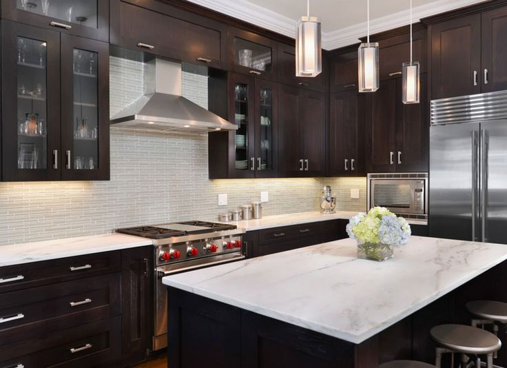 a large kitchen with an island and stainless steel appliances