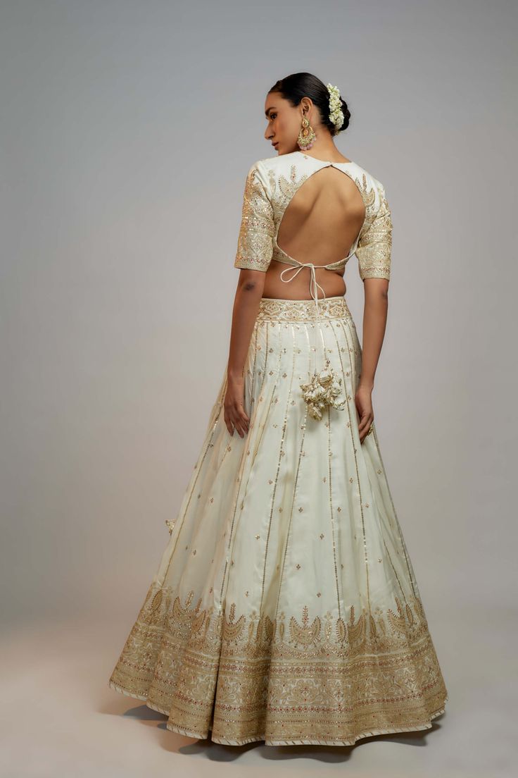 Editor's Note This lehenga set is ideal for a glamorous wedding ceremony, radiating elegance and grace. The marodi work makes it a statement piece, guaranteed to turn heads and leave a lasting impression. Prepare to steal the spotlight and make a memorable entrance on your special day. The beautiful craftsmanship and intricate details will make you feel like a queen. Marodi Work, White Lehenga, Zardosi Work, Indian Arts And Crafts, Personal Shopping Service, Steal The Spotlight, Glamorous Wedding, Custom Tailoring, Indian Design