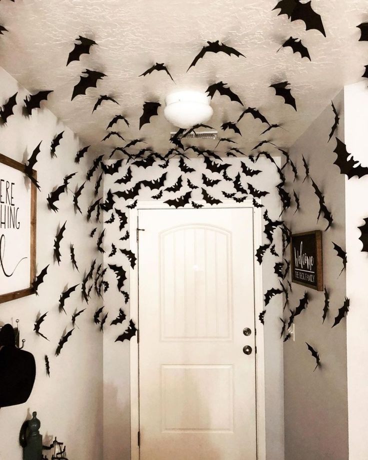 a hallway decorated for halloween with bats on the ceiling