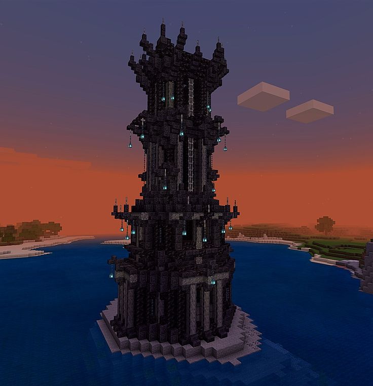 a tall tower sitting on top of a body of water in front of a sunset