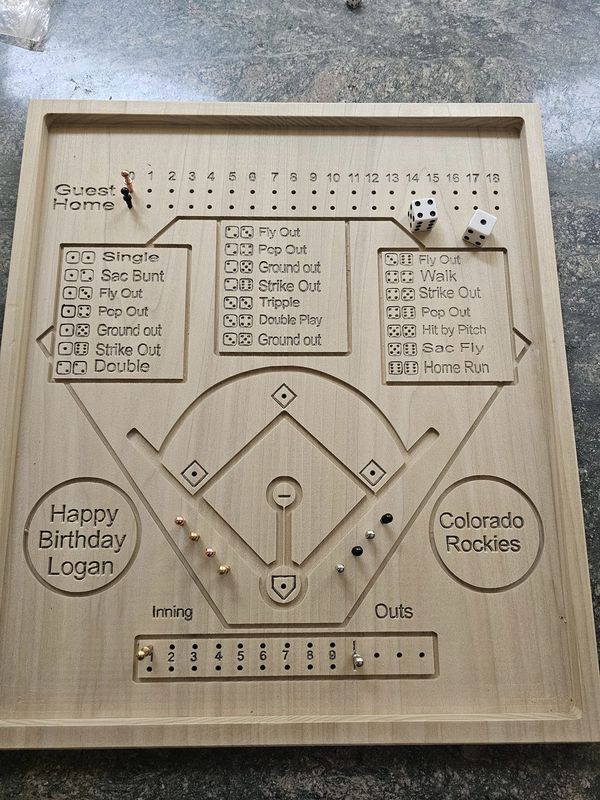 a wooden baseball game board on the ground