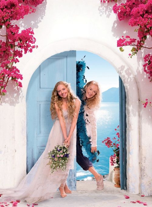 the movie poster for mamma mia starring two women in white dresses and one is holding a bouquet