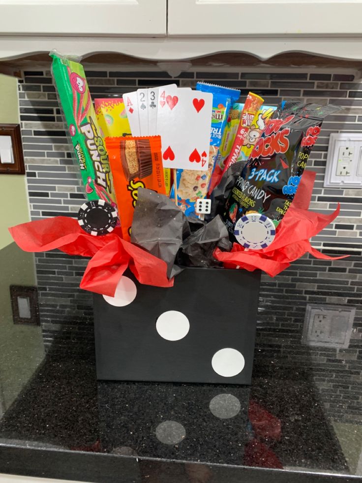 a black box filled with lots of candy and candies on top of a counter