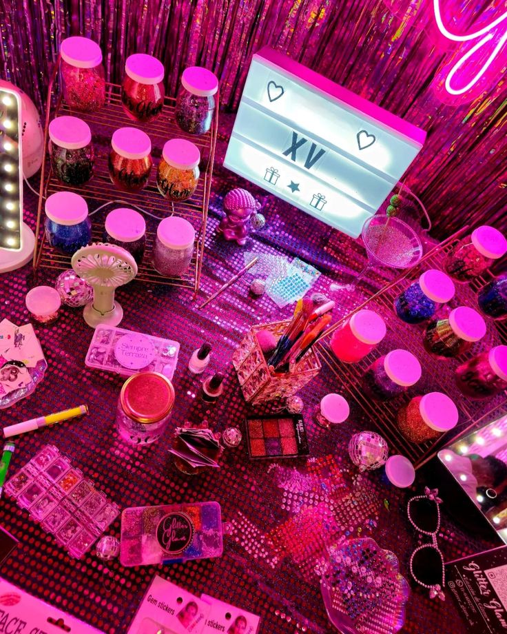 a table topped with lots of different types of makeup and other items on top of it