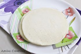 a white plate topped with two tortillas on top of a purple and green napkin