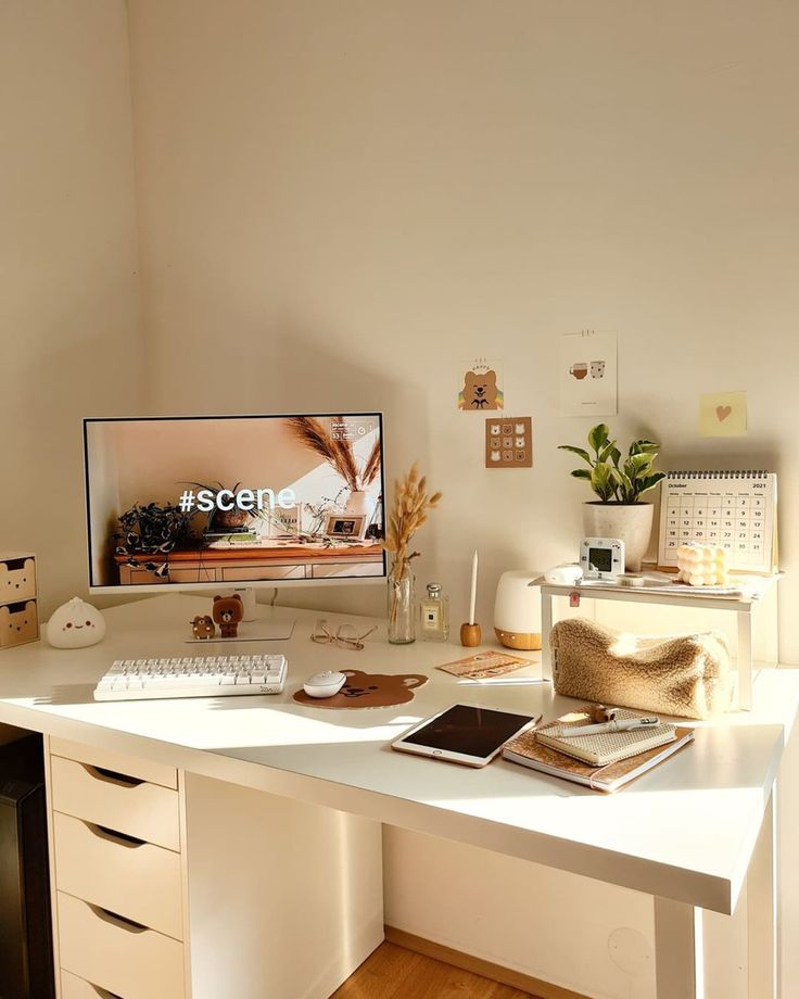 a white desk with a computer monitor and keyboard sitting on it's top shelf