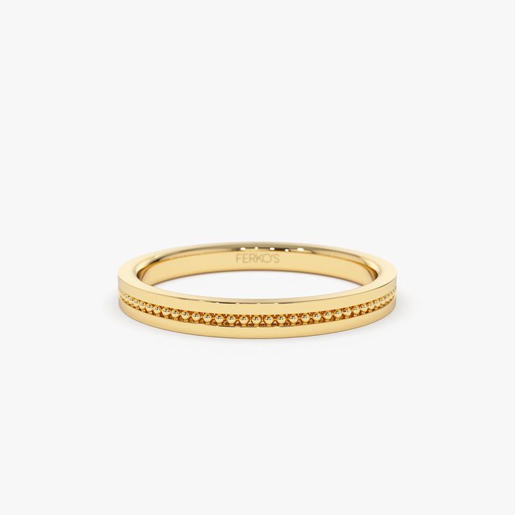 a yellow gold band with small diamonds on it