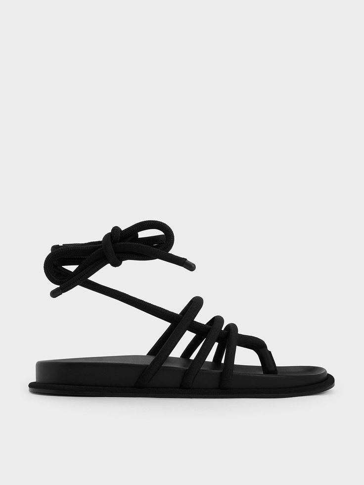 For all your poolside hangouts and beachy getaways, these Toni sandals will come in handy. The tubular, strappy design adds subtle tactility to the black finish, which refreshes the classic sandal style. For a customised fit, the tie-around straps make it easy ot find your preferred fit. Complete with cushioned in-soles for all-day comfort, these sandals will be your go-to shose all season long. Black Sandals With Adjustable Straps For Beach, Adjustable Black Lace-up Sandals For The Beach, Black Strappy Sandals For The Beach, Black Strappy Flip Flops For Beach, Black Strappy Flip Flops For The Beach, Black Summer Sandals For Poolside, Black Open Toe Sandals For Poolside, Black Sandals For Spring Poolside, Sandal Style