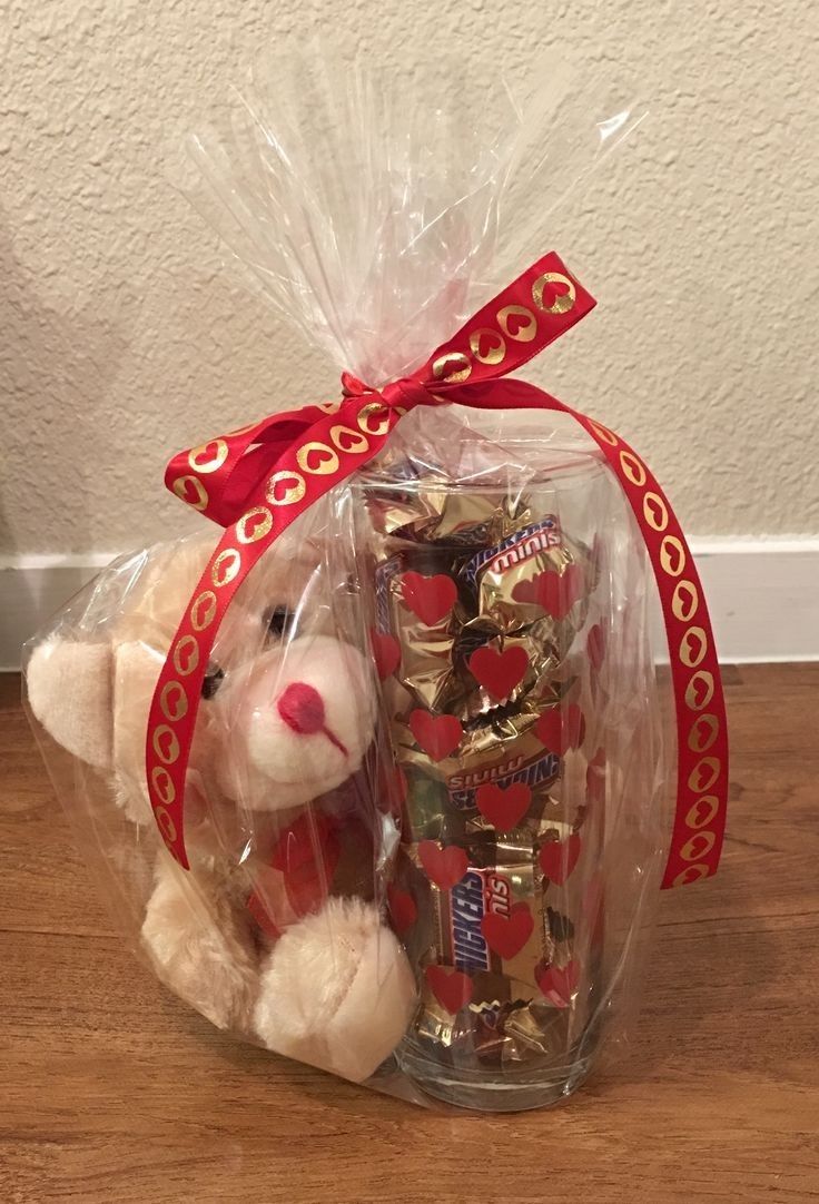 a teddy bear in a bag filled with chocolates