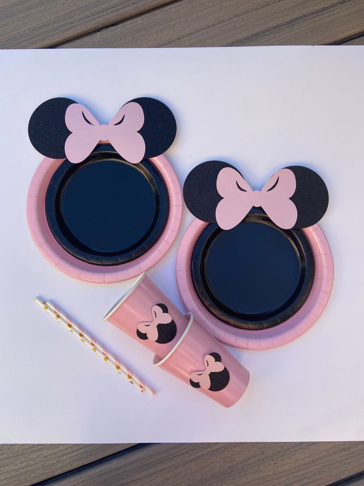 a pair of mickey mouse ears with pink and black rims on top of each other