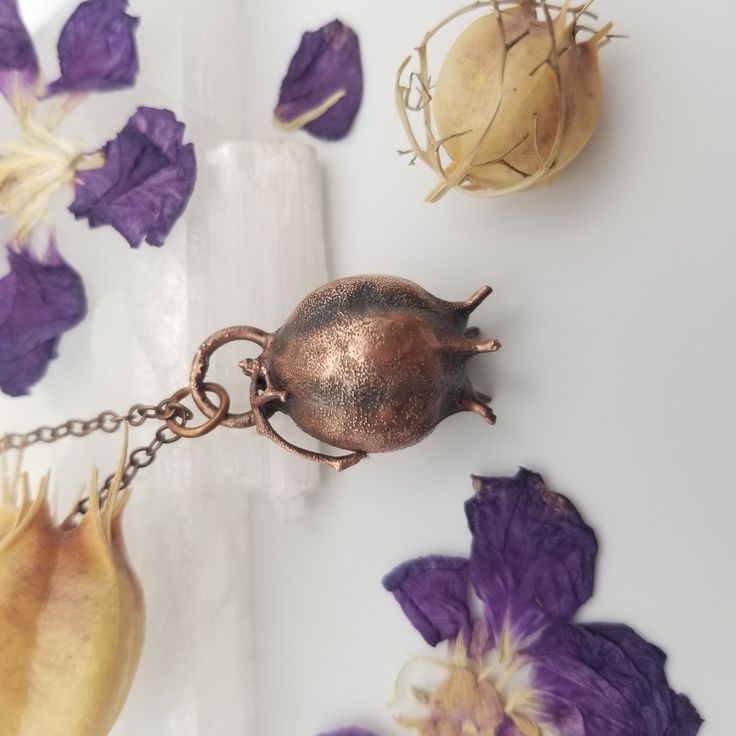 Nigella Seed Pod Copper Electroformed Necklace. Another piece of nature from my mother's collection. This is a real Nigella seed pod, preserved in copper. This one was a very delicate process 😅 These seed pods are pretty fragile. https://eyeofeva.etsy.com/listing/1664897161/nigella-seed-pod-copper-electroformed #electroformedjewelry #electroformingartist #copperjewelry #electroforming #witchyjewelry #handmadejewelry #darkjewelry #naturaljewelry #electroformedorganics Spiritual Copper Jewelry With Natural Stones, Spiritual Copper Necklace With Natural Stones, Spiritual Copper Necklaces With Natural Stones, Healing Copper Jewelry With Gemstone Beads, Spiritual Copper Gemstone Necklace, Spiritual Copper Necklace With Gemstone, Copper Gemstone Pendant Jewelry, Artisan Jewelry With Gemstone Beads As Gift, Artisan Jewelry With Gemstone Beads For Gifts