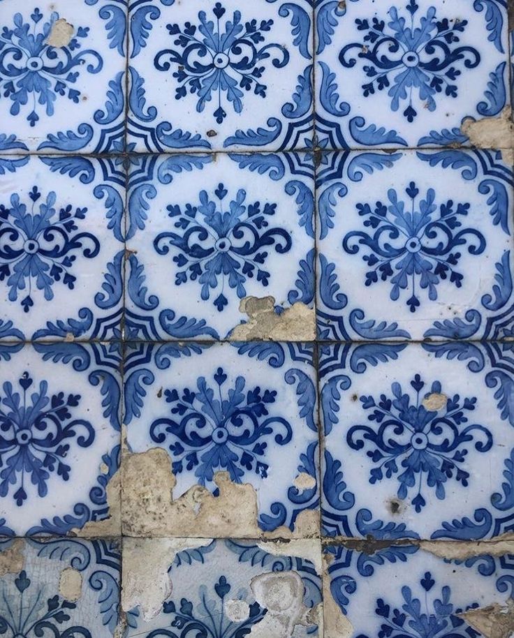 blue and white tiles with designs on them