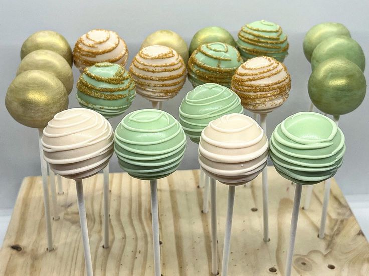 there are many green and gold cake pops