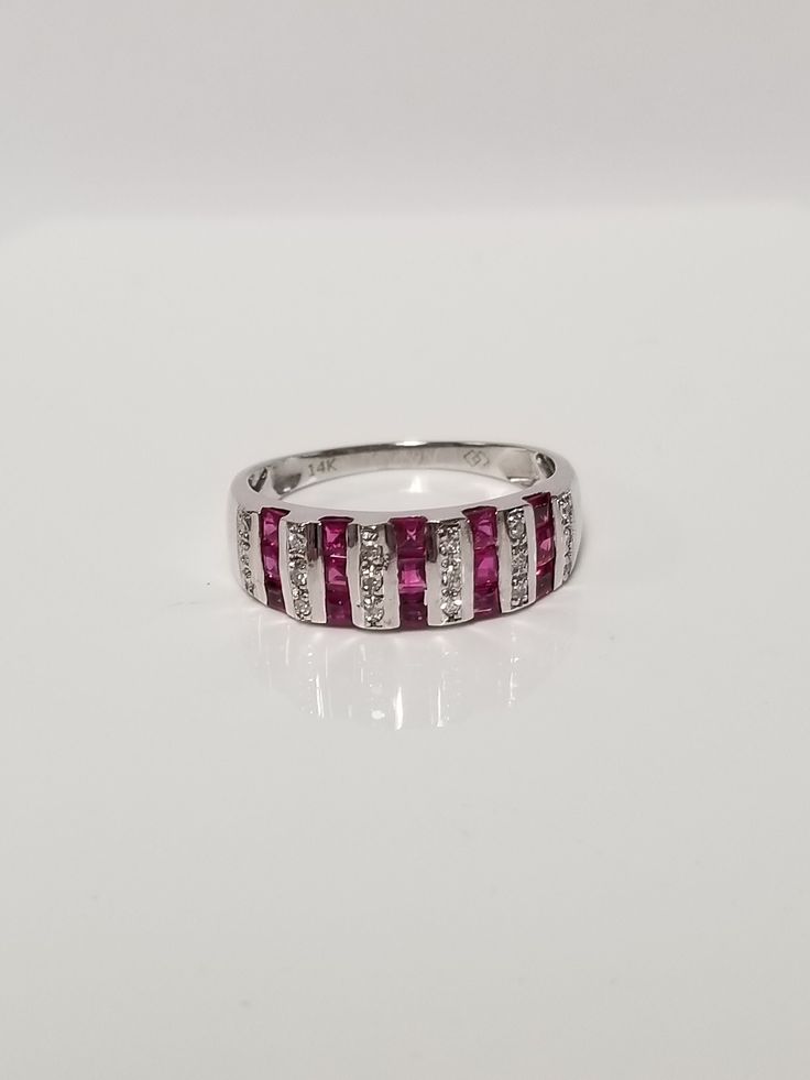 "Thanks for shopping our vintage estate store. We tend to sell well below wholesale and truly hope you enjoy all of our items. Many of the items are one of a kind, so please enjoy scrolling through the pictures and hopefully something will catch your eye. Brown spots are from camera or reflections. Beautiful estate 14k white gold round cut .50ct ruby diamond band. There are 15 rubies for .35ct and 18 diamonds for .15ct. Rubies are Burmese and stunning. Ring size: 7 Setting: 6mm 1/4\" by 5/8\" Weight: 3.0 grams Band width: 1.5mm Clarity: SI2 Color: H Marked 14k and is a really nice band." Red Diamond Rings With Channel Set, Red Diamond Channel Set Rings, Fine Jewelry Ruby Ring With Diamond Channel Set, Fine Jewelry Diamond Channel Set Ruby Ring, Anniversary Ruby Jewelry Channel Set, Luxury Diamond Channel Set Ruby Ring, Ruby Channel Set Jewelry For Anniversary, Channel Set Ruby Jewelry For Anniversary, Emerald Cut Ruby Ring With Diamond Accents For Anniversary