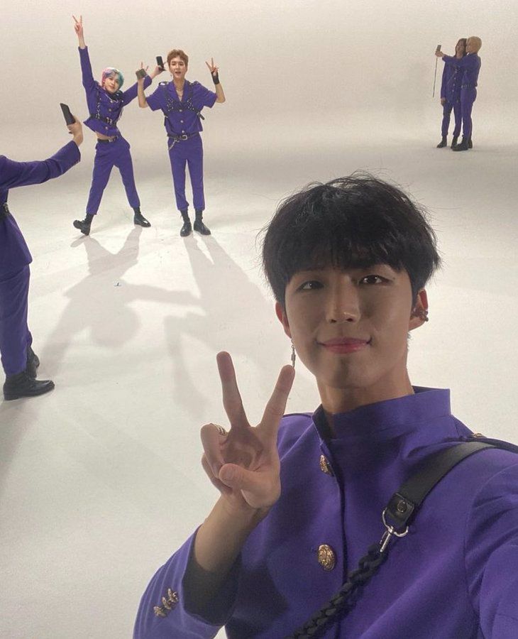 a group of people standing on top of a ice covered rink holding up peace signs