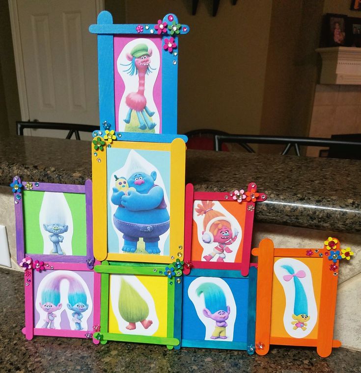 there are many different pictures on this colorful block set that is sitting on the counter