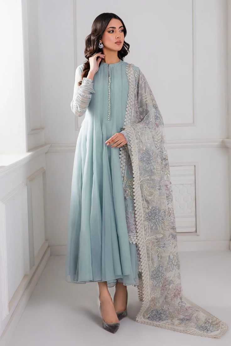 Introducing our stunning Light Blue Chiffon Silk Suit Anarkali Dress, complete with an embroidered net dupatta and a grip silk trouser. Create a head-turning look with this elegant 3-piece set, including the top, trouser, and dupatta, along with accompanying accessories. Elevate your style with the luxurious embroidered chiffon fabric. Top Fabric: Chiffon Dupatta Fabric: Embroidered Net Trouser Fabric: Grip silk Top Length: 50"-52" Sleeves Length: 21"-23" Bottom Length: 36"-37" Condition: New Oc Pastel Blue Anarkali, Pakistani Dupatta Designs, Pakistani Frock Design, Blue Pakistani Dress, Dyed Pants, Pakistani Party Wear, Party Frocks, Pakistani Fancy Dresses, Salwar Kamiz