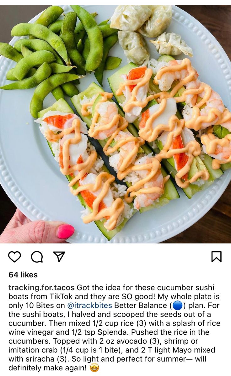 a white plate topped with cucumbers covered in sauce next to green beans and peas