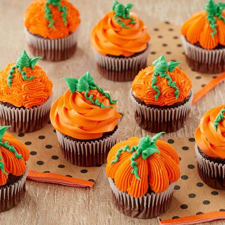 cupcakes decorated with orange frosting and green leaves