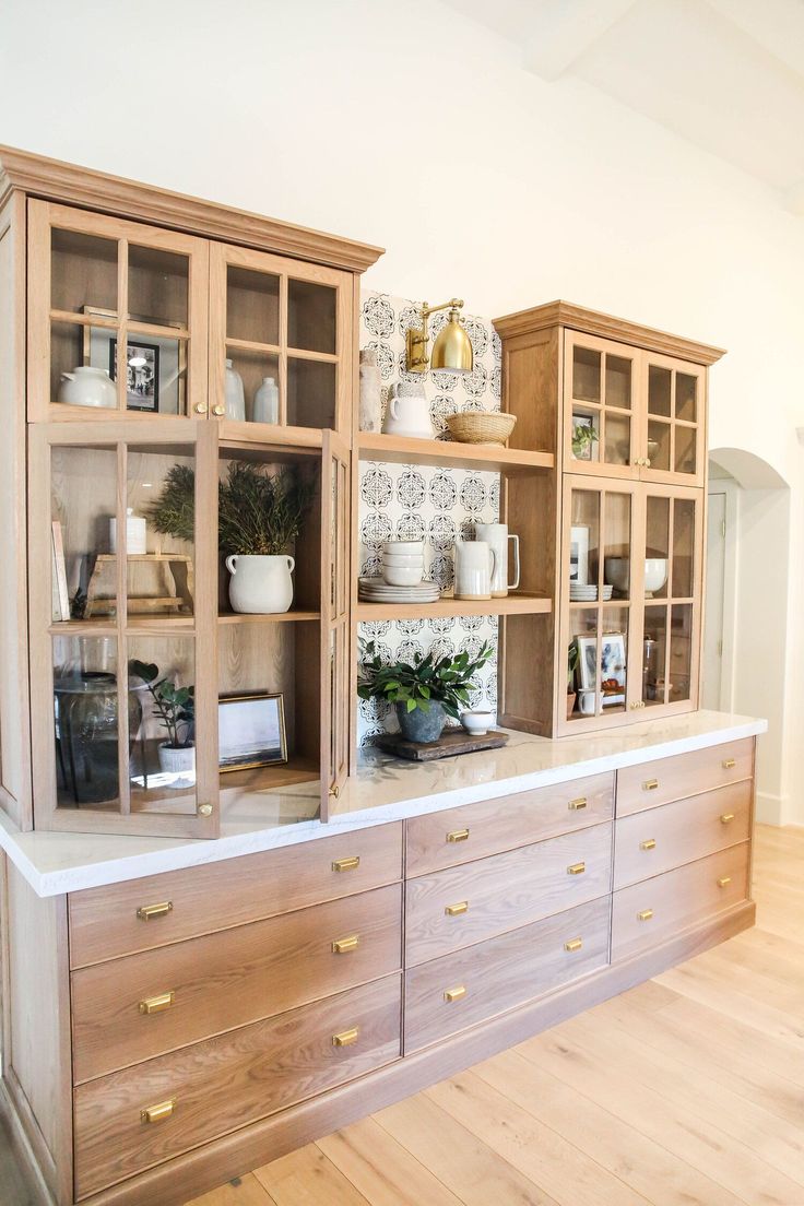 a kitchen with wooden cabinets and white counter tops