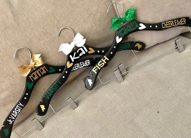 a pair of scissors that have been decorated with green and gold ribbon on the handles