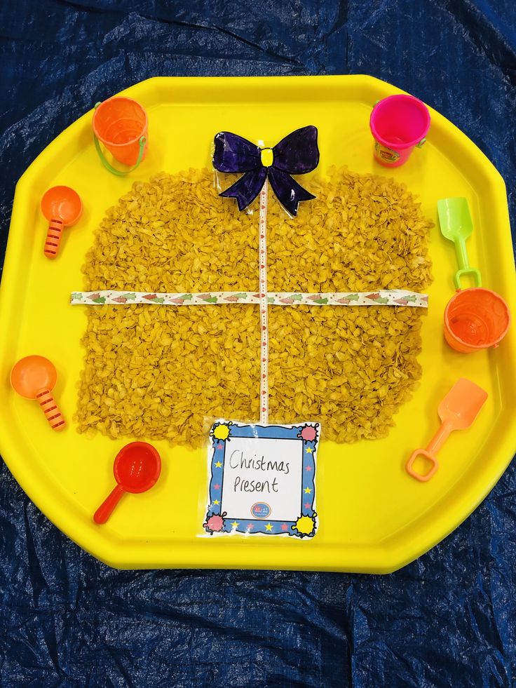 a yellow plate topped with rice krispy treats on top of a blue table cloth