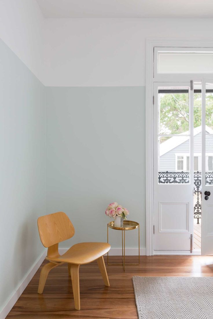 a chair and table in front of a white door with glass doors on both sides