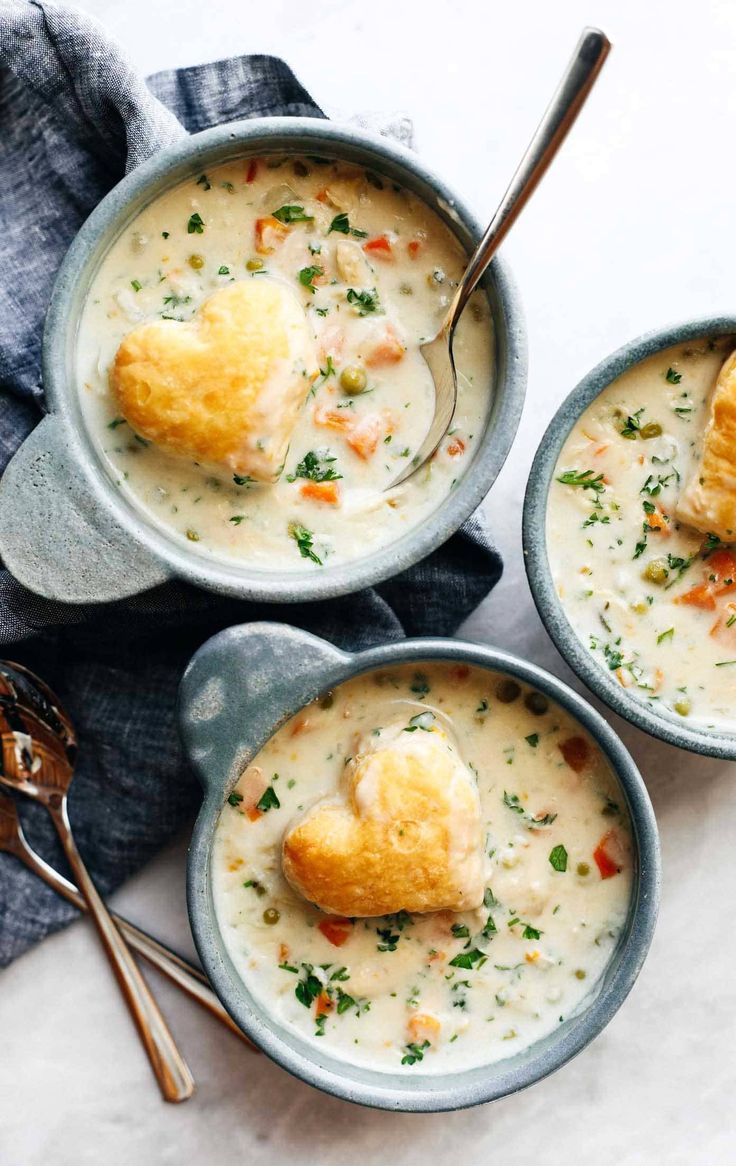 three bowls filled with soup on top of a table