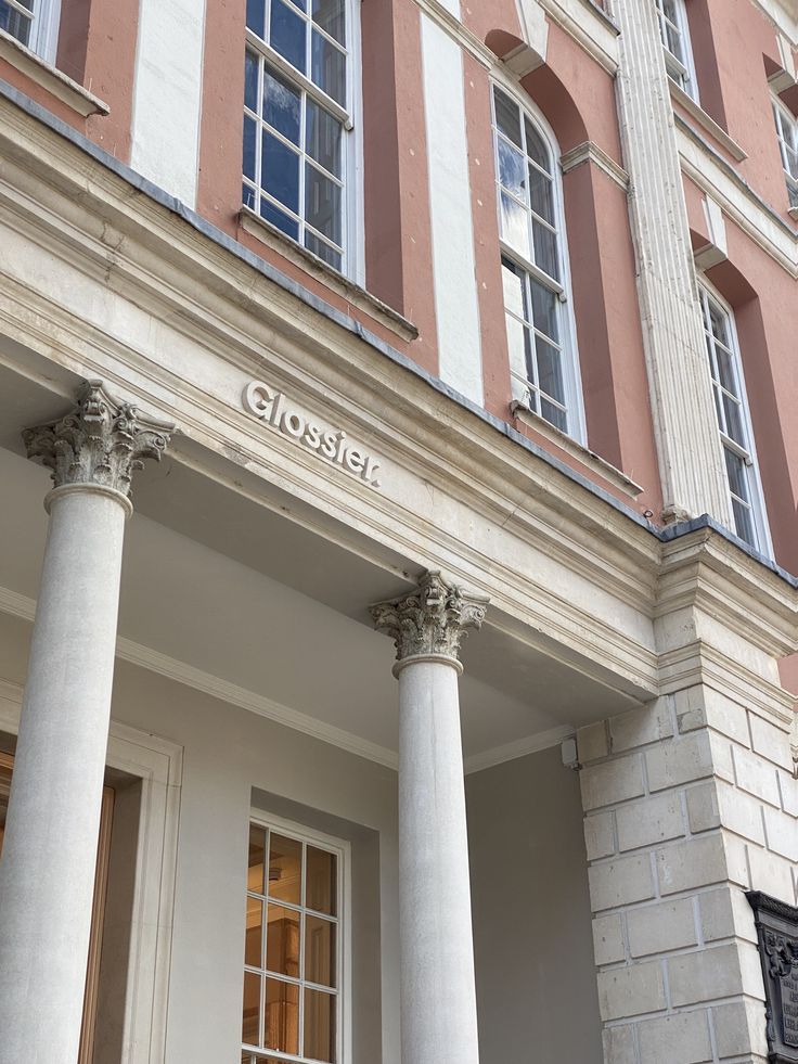 the front of a building with columns and windows