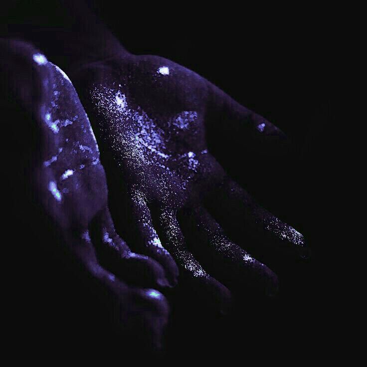 a person's hand covered in purple glitter