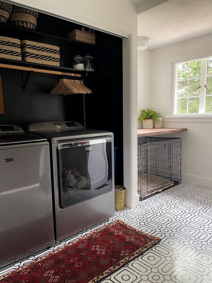 a washer and dryer in a laundry room with a rug on the floor