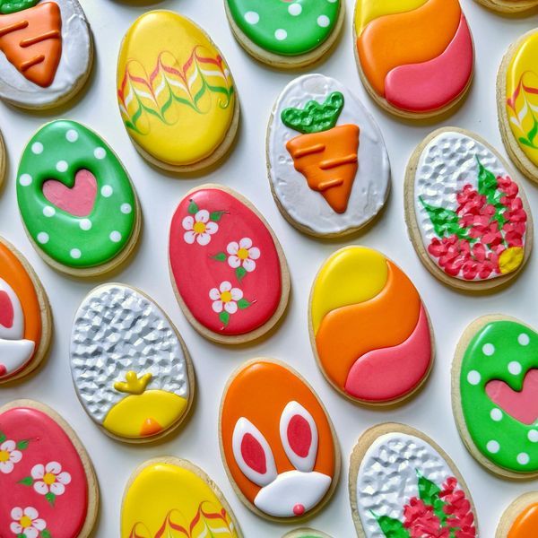 decorated cookies are arranged on a white surface