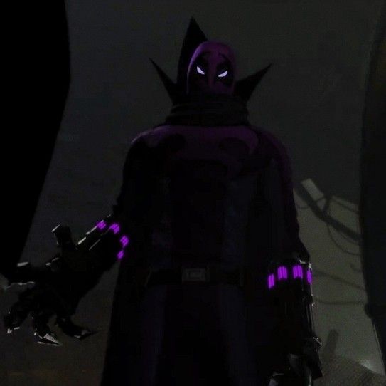 a man in a dark suit with purple lights on his face and hands, standing next to another person