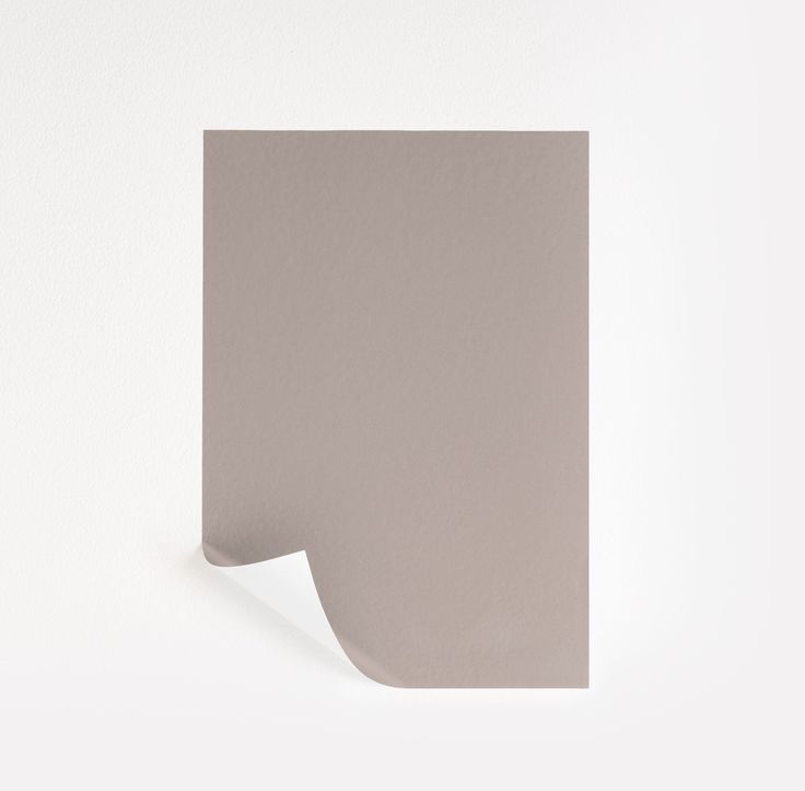 the corner of a piece of paper is shown with a white wall in the background