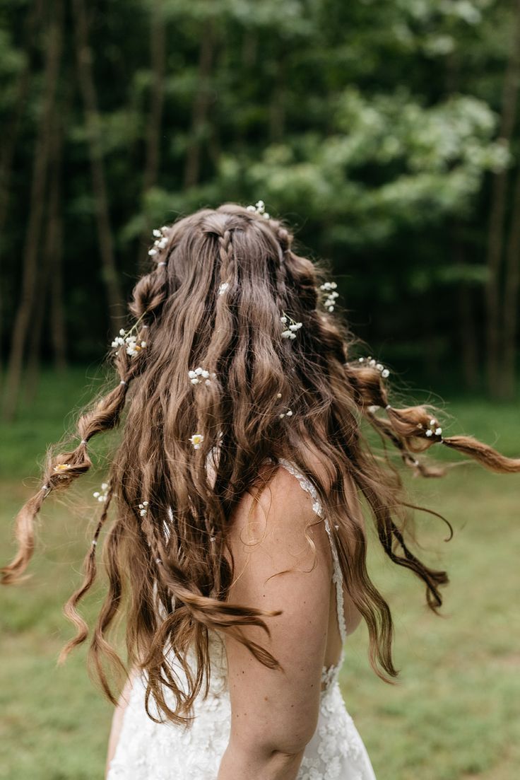 a woman with long hair and flowers in her hair