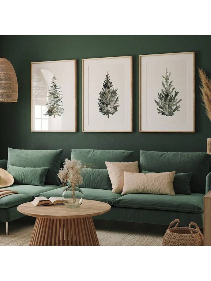 a living room with green walls and pictures on the wall, two plants in vases