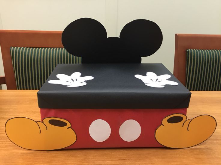 a mickey mouse box sitting on top of a wooden table