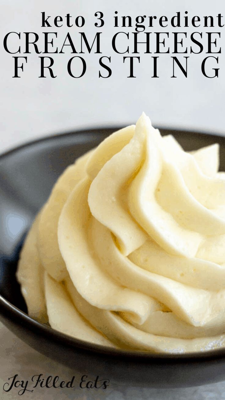 a black bowl filled with cream cheese frosting