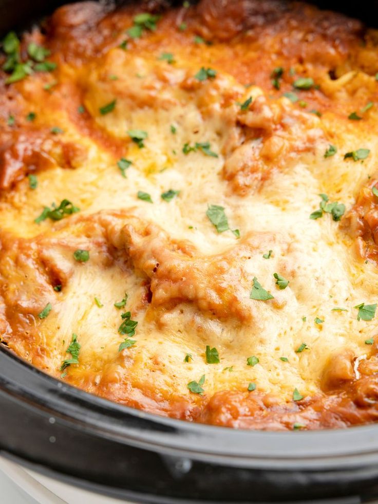 a casserole dish with meat and cheese in the crock pot, ready to be eaten