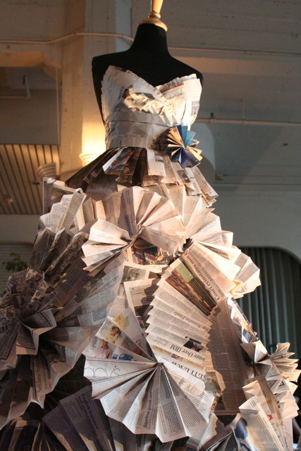 a dress made out of folded paper on display