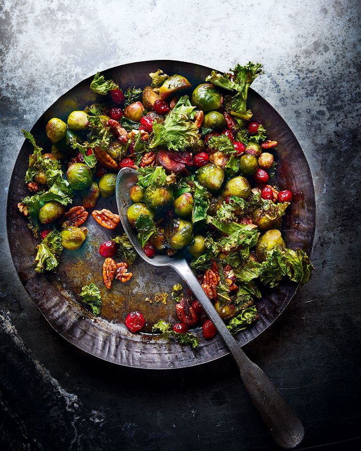 a plate filled with brussel sprouts and pomegranates