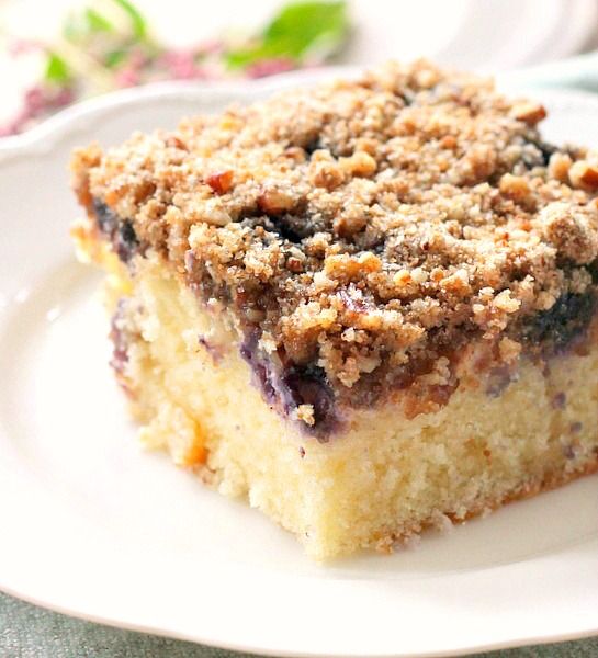 a piece of blueberry crumb cake on a white plate