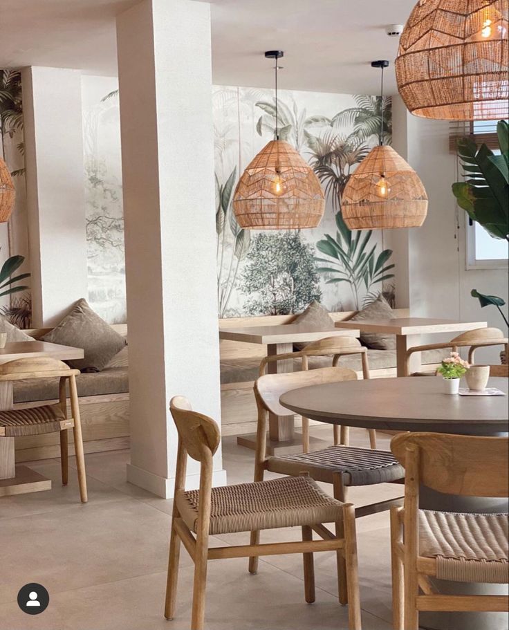 an indoor dining area with wicker chairs and wooden tables