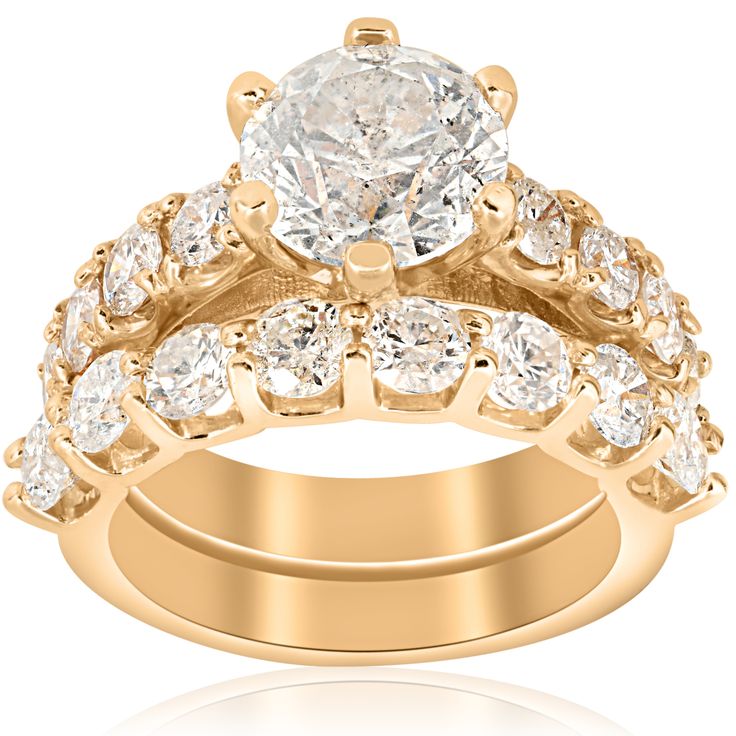 a gold wedding ring set with two rows of diamonds on the band and an oval shaped center