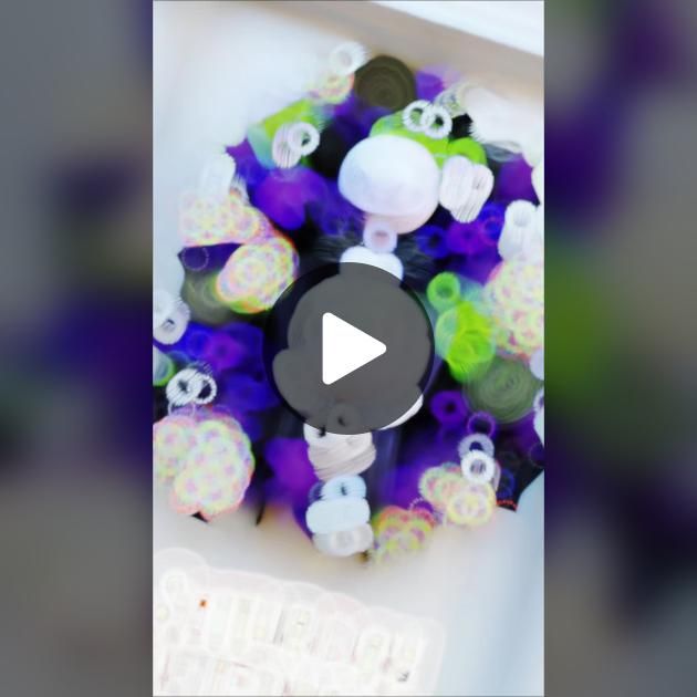 the video is showing how to make an ornament wreath with beads and buttons